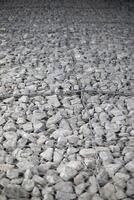 Texture of stones. Stones under the net. Drainage system. photo