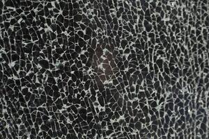 Small cracks on the glass. Texture of broken glass. Lots of chaotic fragments. photo