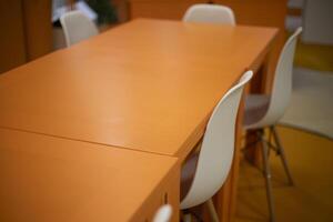 Orange table. Chairs at the table. Empty places. photo