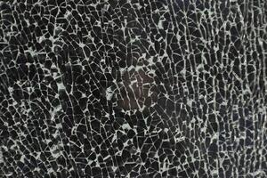 Broken glass. Cracks on the window. Small fragments. photo