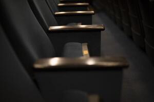 Chair in the cinema. Seating in the hall. Free space. photo