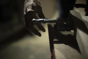 Clamp in workshop. Board holder. photo