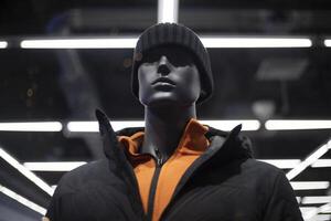 Black mannequin. Mannequin of a young guy in a hat. Selling clothes in a shopping center. photo