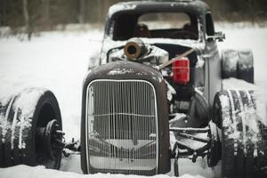 Old American car is parked in snow. Retro car in snow. Abandoned vehicles. photo
