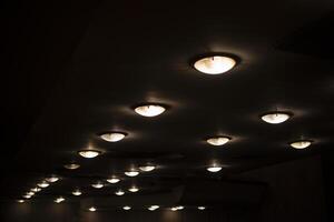 Round lamps on the ceiling. Lots of lamps in a row. Ceiling in the Great Hall. photo