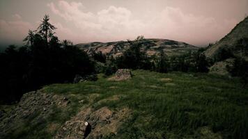 Serene landscape view of rugged hills and green grass under an overcast sky video