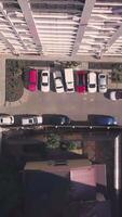 Top view of roof of multi-storey building with parked cars in yard. Clip. Horizontal top view of multi-storey building with courtyard video