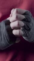 Man flexing his fists before a fight. Close-up of a young Thai boxer hands hemp ropes are wrapped before the fight or training. video