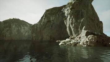 Serene rocky coastline with calm waters on a bright day video