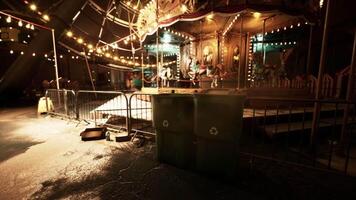 Deserted amusement park at night featuring an empty carousel and dim lighting video