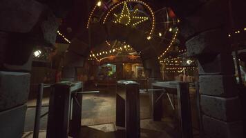 Empty amusement park entrance at night with illuminated attractions and rides video
