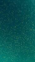 Glitter fluid abstract background with flowing particles. Media. Shimmering glowing grainy texture of turquoise color. Vertical . video