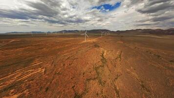 A wind turbine rotates in a field in Australia, drone . video