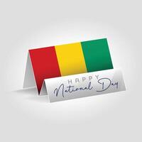 Guinea country paper flag standing on the ground. Happy national day flag design. vector