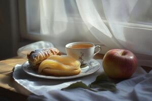 A plate with a croissant and an apple on it photo