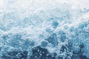 A close up of a wave with bubbles photo