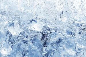 Ice water background with ice cubes photo