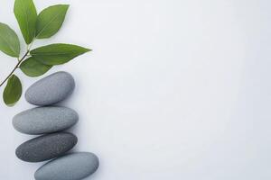 Three stones and a leaf on a white background photo