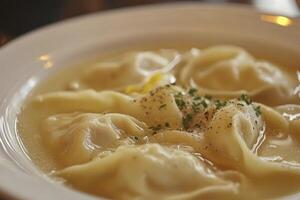 A bowl of dumplings with a spoon in it photo