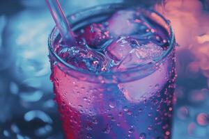 A glass of soda with ice and a straw photo