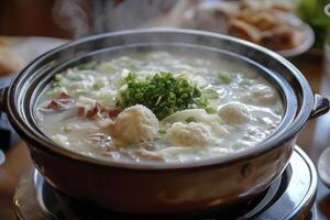 A pot of soup with meat and vegetables on top photo