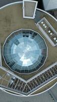 Top view of modern round building with dome. Stock footage. Beautiful architecture of business center with round structure and dome. Rings of building with beautiful facade video
