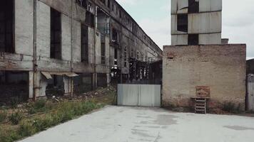 Take-off of the drone at an abandoned factory. Old abandoned factory building. Aerial View video
