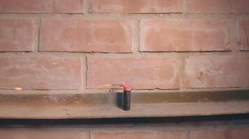 Firecracker Was Lighted Up With a Gasoline Lighter then Explode Against a Brick Wall - Super Slow Motion. Many Small Particles Flew in a Different Directions - Static Shot video
