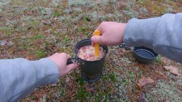 Camp Food. Cooking in a Forest Using a Small Cook Set - First Person View, Wide Angle. Food on the Trip. Traveler in a Forest. Tourist in a Travel is Heating Food - POV Shot video