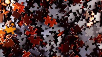 Background of Colored Puzzle Pieces that Rotating Clockwise - Top View. Texture of Incomplete Red and Grey Jigsaw Puzzle with Low Key Light - Right Rotation video