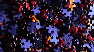 Background of Colored Puzzle Pieces that Slowly Rotating Counterclockwise - Top View. Texture of Incomplete Red and Blue Jigsaw Puzzle with Low Key Light - Left Rotation video