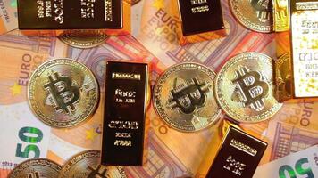 Shiny Gold Bars with Bitcoin on the 50 Euro Bills - Top View. Euro Money Currency. A Lot of Fifty Euro Banknotes. Success, Finances, Cryptocurrency and Wealth Concept - Slow Rotation Right video
