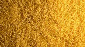 Background of Uncooked Noodles that Slowly Rotating Clockwise - Top View. Texture of Dry Vermicelli Turning Around. Raw Pasta with Low Key Light - Right Rotation video