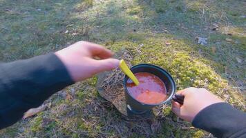Camp Food. Cooking in a Hike Using a Small Cook Set - First Person View, Wide Angle. Food on the Trip. Traveler in a Spring Forest. Tourist in a Travel is Heating Food - POV Shot. video