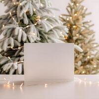 Blank white greeting card mockup in a Christmas scene. Warm and cozy aesthetic christmas scene background with a blank paper with copy space. photo