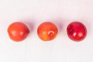 Red plum fruit on the white background isolated top view photo