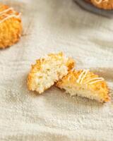 Delicious coconut macaroons cookies showing soft inside on linen cloth photo