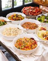 Different salads on the white table photo