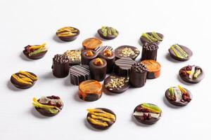 Chocolate pieces on the white background, top view photo