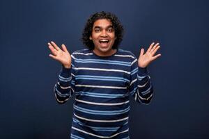 Young handsome man over gray background afraid and shocked with surprise and amazed expression, fear and excited face. photo
