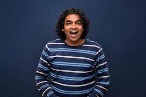 Young handsome man over gray background afraid and shocked with surprise and amazed expression, fear and excited face. photo