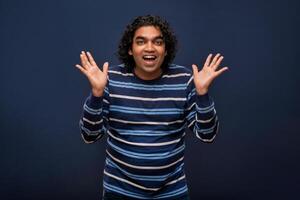 Young handsome man over gray background afraid and shocked with surprise and amazed expression, fear and excited face. photo