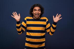 Young handsome man over gray background afraid and shocked with surprise and amazed expression, fear and excited face. photo