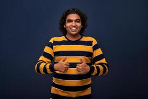 retrato de un exitoso alegre joven hombre señalando y presentación OK, victoria firmar con mano o dedo con un contento sonriente rostro. foto
