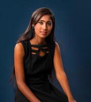 Portrait of a young beautiful girl posing on gray background photo