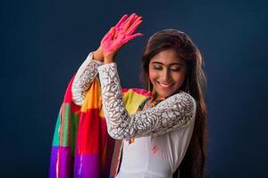 A beautiful young girl plays with colors on the occasion of Holi. The concept for the Indian festival Holi photo