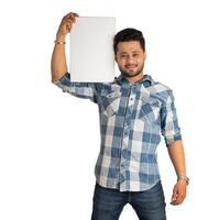 A happy young man holding and displaying a signboard or placard in his hands on a white background. photo