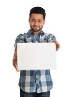 A happy young man holding and displaying a signboard or placard in his hands on a white background. photo