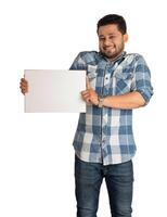 A happy young man holding and displaying a signboard or placard in his hands on a white background. photo