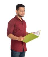 Young happy man holding and posing with the book on white background. photo